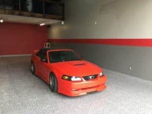 amazing epoxy garage with red mustang